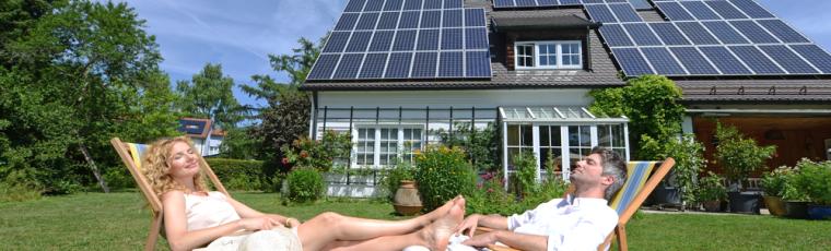 Couple relaxing near their solar panels with injection tarif