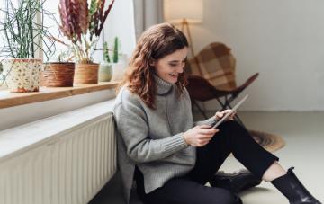Woman optimizing her heating to save energy