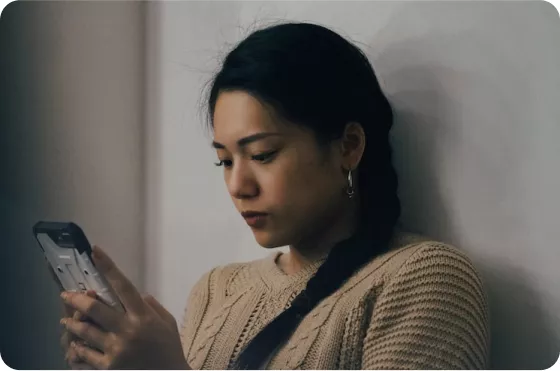 Woman checking her energy consumption on her smartphone