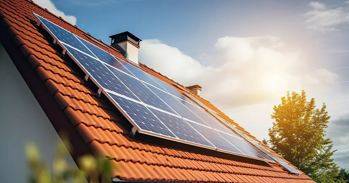 Solar panels on a roof with sun shining